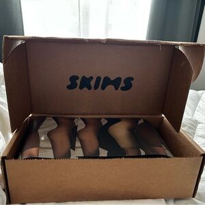 Two skims plunge bras. Nude and black.